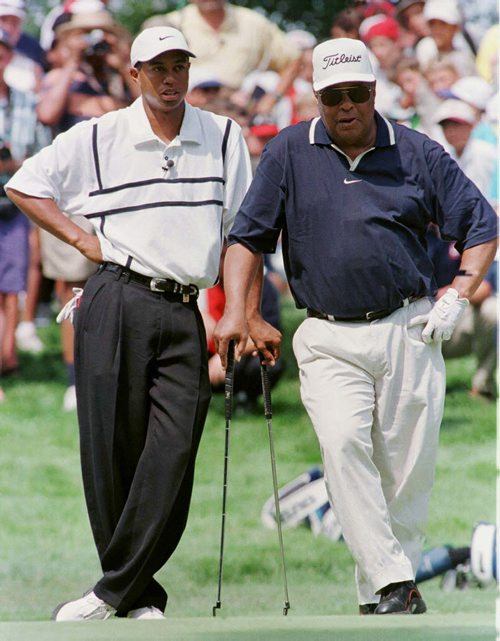 Defending champion of the Motorola Western Open, Tiger Woods, (L) and his father, Earl Woods, strike similar poses during the Western Open Family Challenge at Cog Hill Golf & Country Club, in the Chicago suburb of Lemont, Illinois, June 23. The Western Open begins play June 25.    SUE/SB