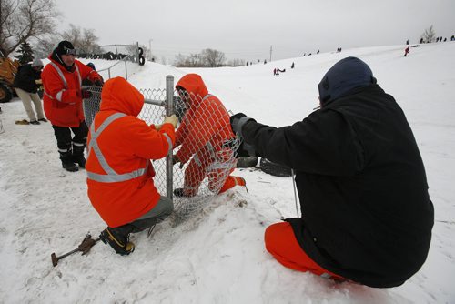 December 29, 2010 - 101229  -   Winnipeg city crews build a fence and install tires to help protect sledders at Garbage Hill on Wednesday, December 29, 2010. John Woods / Winnipeg Free Press