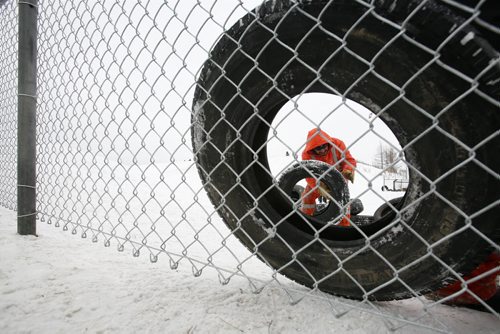 December 29, 2010 - 101229  -   Noah Whitford and city crews build a fence and install tires to help protect sledders at Garbage Hill on Wednesday, December 29, 2010. John Woods / Winnipeg Free Press