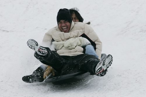 December 29, 2010 - 101229  -   Mary and Andy Lejarzo go sledding on Garbage Hill today. Winnipeg city crews build a fence and install tires to help protect sledders at Garbage Hill on Wednesday, December 29, 2010. John Woods / Winnipeg Free Press