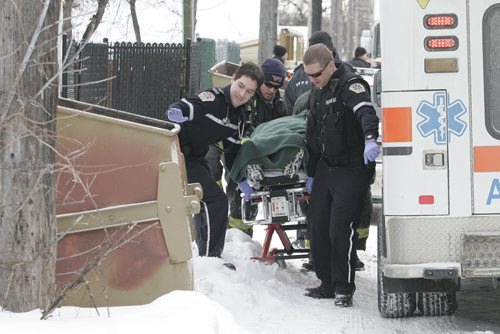 January 1, 2011 - 110101  - Emergency personnel remove a victim from the rear of 325 Manitoba Avenue on Saturday, January 1, 2011. John Woods / Winnipeg Free Press