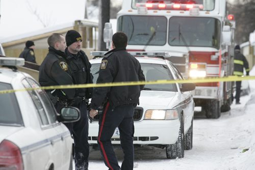 January 1, 2011 - 110101  - Police investigate after emergency personnel remove a victim from the rear of 325 Manitoba Avenue on Saturday, January 1, 2011. John Woods / Winnipeg Free Press