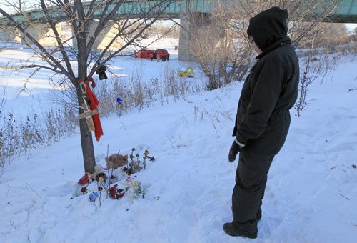 JOE.BRYKSA@FREEPRESS.MB.CA Local- ( see story) - Mother Mclaine Flett of missing 6 year old   Nathaniel Thorassie watches as Winnipeg Police Underwater Recovery Team  dive Sunday morning in the icy waters of the Red River under the bridges of the Disraeli Freeway  near a vigil she has set up since he has been missing- Winnipeg police divers have joined forces with the  Canadian Amphibious Search Team in tandem dives to  look for the body of 6 year old Nathaniel Thorassie who fell through the ice and is prusumed drowned on Dec 04, 2010-  Jan 02, 2011- JOE BRYKSA/WINNIPEG FREE PRESS