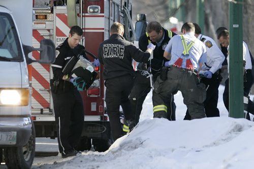 January 4, 2011 - 110104  - Emergency personnel remove an infant in critical condition from 514 Boyd Tuesday afternoon, January 4, 2011.  John Woods / Winnipeg Free Press