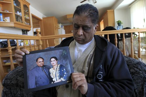MIKE.DEAL@FREEPRESS.MB.CA 110105 - Wednesday, January 05, 2011 - Randhir Singh Sodhi holds an undated family photo of his brother Rajinder Pal Singh Sodhi and sister-in-law Adrash Kaur Sodhi. Rajinder, a 57-year-old Winnipeg cab driver injured in a crash on Monday morning has died. According to a family member Rajinder, also known as Paul to his friends, family and colleagues, had just picked up his second fare of the day when his Duffys taxi collided at about 6:30 a.m. on Monday with another vehicle at the intersection of Sargent Avenue and King Edward Street. MIKE DEAL / WINNIPEG FREE PRESS