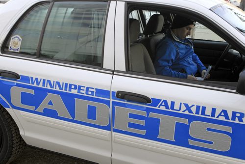 MIKE.DEAL@FREEPRESS.MB.CA 110105 - Wednesday, January 05, 2011 - Auxilary Police Force Cadet, Justin Malec, takes some notes in his car after a press conference. MIKE DEAL / WINNIPEG FREE PRESS
