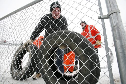 December 29, 2010 - 101229  -   Winnipeg city crews build a fence and install tires to help protect sledders at Garbage Hill on Wednesday, December 29, 2010. John Woods / Winnipeg Free Press