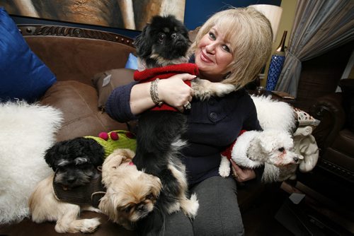 January 06, 2011 - 110106  - Barbara Camara cuddles with (L to R)  MJ, Naples, Chuckie and Bella, four of her six dogs, in her Winnipeg home Thursday, January 06, 2011.    John Woods / Winnipeg Free Press