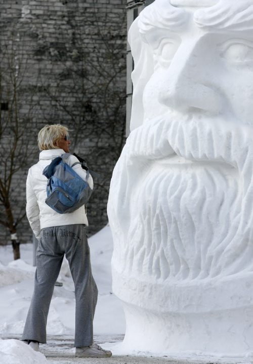 MIKE.DEAL@FREEPRESS.MB.CA 110111 - Tuesday, January 11, 2011 - A pedestrian checks out a large snow sculpture in the courtyard of 201 Portage Ave. in downtown Winnipeg. MIKE DEAL / WINNIPEG FREE PRESS