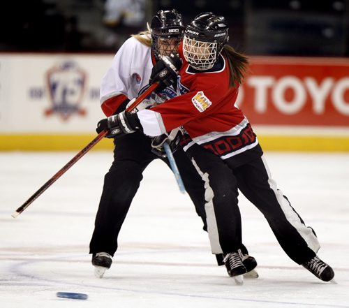 PHIL.HOSSACK@FREEPRESS.MB.CA 110112-Winnipeg Free Press A Boston Belle (in Red) and A Southern Belle (white) duke it out at center ice Wednesday at the MTS Center in the Wpg Ringette Leaugue Belles' All Star Game.......No rosters or info available, See release...."Stand-up" assignment.....