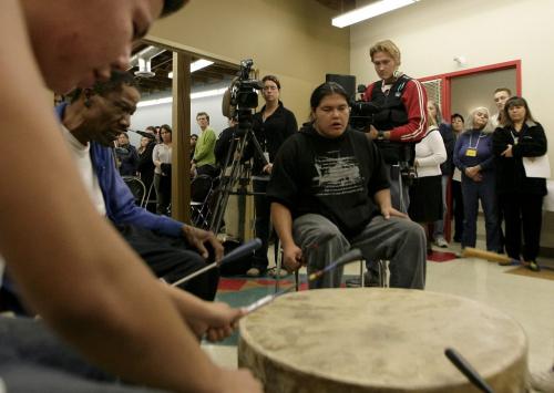 John Woods / Winnipeg Free Press / October 5, 2006 - 061005 - People gather around the drum for an honour song at the grand opening of the Ka Ni Kanichihk community training and resource centre on McDermot Avenue Thursday, Oct. 5/06.