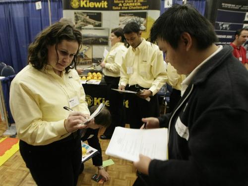 John Woods / Winnipeg Free Press / October 5, 2006 - 061005 -Vanessa Heron, senior staff recruiter for Kiewit, a industrial construction firm, reviews the resume of University of Manitoba engineering student Mui Sen Chong at the annual Agriculture, Food Sciences, and Engineering Career Fair at the U of MB Thursday, Oct. 5/06.
