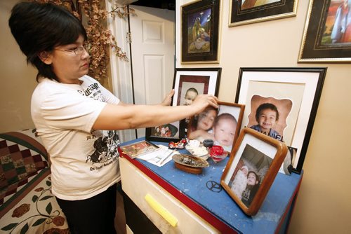January 14, 2011 - 110113  -  In her home on Friday, January 14, 2011 McLaine Flett straightens some  photos of her son Nathanial who drowned in the Red River in early December of 2010. John Woods / Winnipeg Free Press