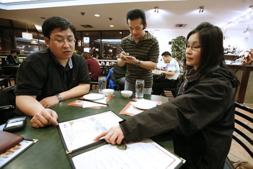 January 14, 2011 - 110113  -  Ziyang Lin, owner of Dim Sum Garden serves Raymond Lai and May Lee at his restaurant Friday, January 14, 2011. Fort Richmond has seen a increased migration of Chinese to the community. John Woods / Winnipeg Free Press