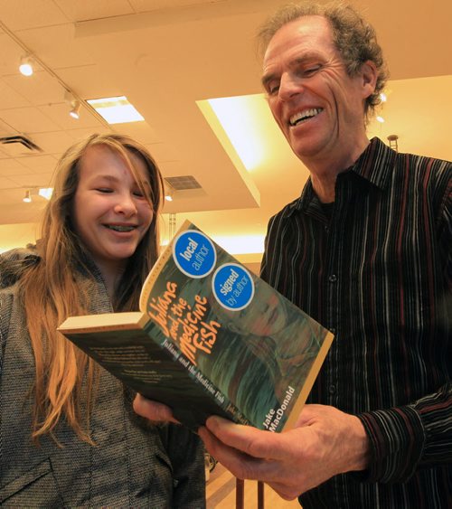 JOE.BRYKSA@FREEPRESS.MB.CA Local- ( standup photo) - Z14 year old Carmen Girard had a chance Sunday afternoon to meet Winnipeg authour Jake MacDonald at Chapters St Vital- He was there signing copies of his hit book Juliana and the Medicine Fish- Recently Manitobans selected  MacDonalds novel Juliana and the Medicine Fish as the years featured book for On the Same Page, a province-wide reading initiative. JOE BRYKSA/WINNIPEG FREE PRESS- JAN 16, 2011