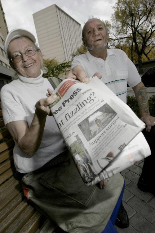 John Woods / Winnipeg Free Press / October 6, 2006 - 061006 - Lillian and Patrick McKeen who met while delivering papers are photographed in front of one of the apartment buildings on their route Friday Oct. 6/06.  It is International Paper Delivers Day