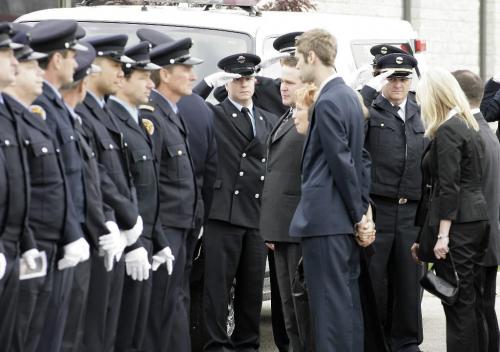 John Woods / Winnipeg Free Press / October 6, 2006 - 061006 - On Friday Oct. 6/06 firefighters from Manitoba and Ontario salute the family of Morris Lawrence as they arrive at the funeral service.  Lawrence reportedly died of work related illness.