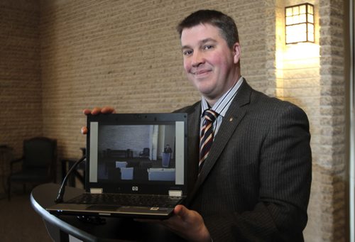 MIKE.DEAL@FREEPRESS.MB.CA 110120 - Thursday, January 20, 2011 - Eirik Bardal with Neil Bardal Funeral Centre holds a laptop that shows a live view of the funeral chaple, an online option for people who can't make it to a service due to distance, weather, etc. See Geoff Kirbyson story MIKE DEAL / WINNIPEG FREE PRESS