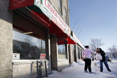 Winnipeg, Manitoba - January 22, 2011 - Stephanie Aguir, an employee of the Lisbon Bakery on Sargent Avenue hands some bread rolls to a customer  Saturday, January 22, 2011.  (John Woods/Winnipeg Free Press)