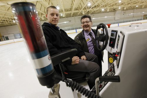 January 25, 2011 - 110125  -  Russell Britton (R), director of facilities at St. Johns Ravenscourt School and Kevin Landry, arena operations coordinator, pose for photographs with their new laser guided ice making machine Tuesday, January 25, 2011.   The unit in the foreground receives the signal from the laser. John Woods / Winnipeg Free Press