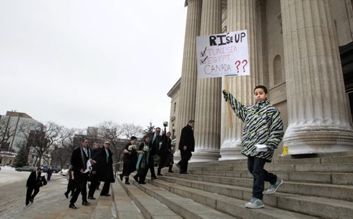 MIKE.DEAL@FREEPRESS.MB.CA 110205 - Saturday, February 05, 2011 - Local Egyptians gathered at the Manitoba Legislature to add their voice to the call for Egyptian President Hosni Mubarak to step aside. A wedding party arrives for photos inside the Legislature while an young protestor walks down the stairs during a gathering of local Egyptians calling for the end of Egyptian President Hosni Mubaraks' reign. MIKE DEAL / WINNIPEG FREE PRESS
