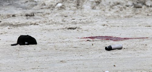 MIKE.DEAL@FREEPRESS.MB.CA 110205 - Saturday, February 05, 2011 - The scene of the double homicide that occured around 2:30 a.m. on Ellen Street at Elgin Avenue just outside the Manitoba Housing block at 425 Elgin. A pool of blood lies spilled in the middle of the road along with a hat, a can of bear spray and at least five spent bullet casings. See Bill Redekop story. MIKE DEAL / WINNIPEG FREE PRESS