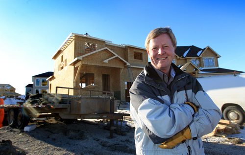 Ruth Bonneville Winnipeg Free Press Feb 10, 2011 Local, Photo of Manitoba Home Builders Association President Mike Moore in front of home being built in Bridgwater Forest  for McNeills story on higher cost of new homes due to new building codes.