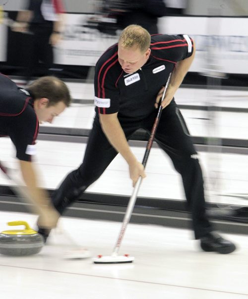 MIKE.DEAL@FREEPRESS.MB.CA 110210 - Thursday, February 10, 2011 - Competitors during the 12:15 draw on the first day of the Safeway Championship in Beausejour, Manitoba. Team Stoughtons' Lead Steve Gould sweeps during a throw by Jeff Stoughton. See Paul Wiecek story. MIKE DEAL / WINNIPEG FREE PRESS