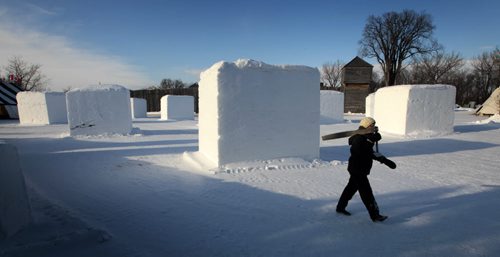 MIKE.DEAL@FREEPRESS.MB.CA 110212 - Saturday, February 12, 2011 - Elyse Saurette first time sculpture for Manitoba Youth Council for Francophones walks through the Festival du Voyageur site at Fort Gibraltar. The Festival starts on Feb 18th and today was the first day for the snow sculptures to start working on their pieces. MIKE DEAL / WINNIPEG FREE PRESS