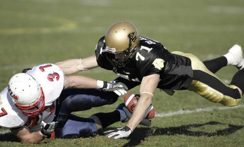 John Woods / Winnipeg Free Press / October 14, 2006 - 061014 -  U of Manitoba Bison SB Simon Blaszczak (71) attempts to recover his own fumble before SFU Clan LB Michael Little (37) gets to it in the second quarter at the U of Manitoba Saturday Oct 14/06.