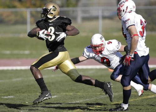John Woods / Winnipeg Free Press / October 14, 2006 - 061014 - U of Manitoba Bison's Randolph Simmons WR (3) avoids a tackle by SFU DB Aeron Kawakami (7)  to run it in for a TD in first quarter action at the U of Manitoba Saturday Oct 14/06.