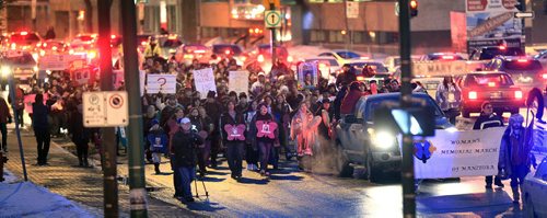 PHIL.HOSSACK@FREEPRESS.MB.CA 110214-Winnipeg Free Press Wreathed in late rush hour traffic marchers in the 4th Annual March for Missing Women walk north on Osborne towards Portage Ave Monday evening. See release story?