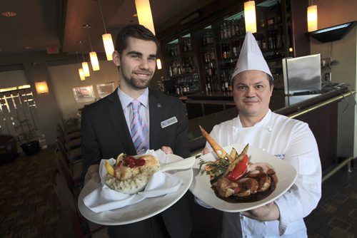 MIKE.DEAL@FREEPRESS.MB.CA 110216 - Wednesday, February 16, 2011 - Restaurant Review Bistro 1800 at the Hilton Suites Tony Vailas, Restaurant Manager and Jamie Szabo, Executive Chef with the Hilton St. Jacques (left) and the Manitoba Pork Loin (right). MIKE DEAL / WINNIPEG FREE PRESS