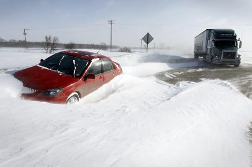 TREVOR HAGAN / WINNIPEG FREE PRESS - A Mitsubishi Lancer sits helplessly in the snow along Inkster as snow accumulates around it. 11-02-18