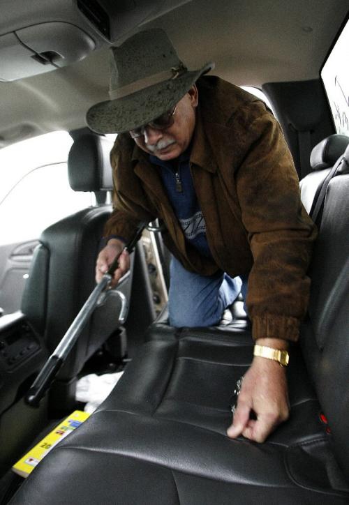 John Woods / Winnipeg Free Press / October 16, 2006 - 061016 - Jim Haines picks up his car security device from the floor of his pickup truck at the MPI compound on Plessis Rd. Monday Oct 16/06.   Haines who is from out of town had his truck stolen yesterday.