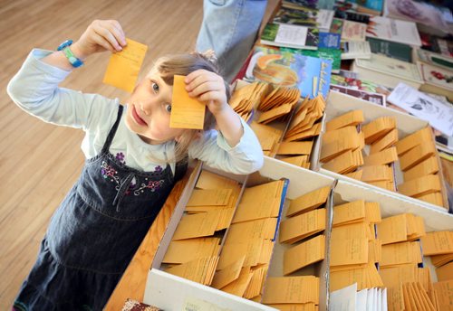 Brandon Sun Autumn Smith holds up packets of sunflower seeds she bought at "Seedy Sunday", at the Park Community Centre. (Colin Corneau/Brandon Sun)