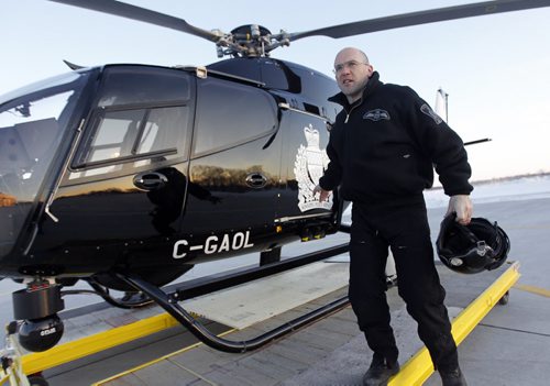 TREVOR HAGAN / WINNIPEG FREE PRESS -Const. Nick Paulet exits Air 1, the Winnipeg Police Service WPS helicopter. 11-02-25