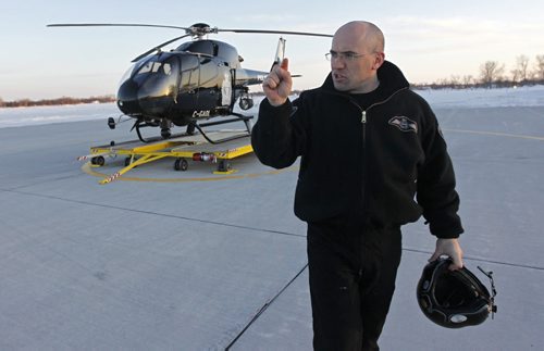 TREVOR HAGAN / WINNIPEG FREE PRESS -Const. Nick Paulet exits Air 1, the WPS helicopter. 11-02-25