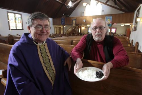 MIKE.DEAL@FREEPRESS.MB.CA 110309 - Wednesday, March 09, 2011 - Rev. Canon Murray Still (left) and Paul Hazelton with a plate of rice and beans that would be the equivalent amount of food a refugee in Africa would get for a single day. The St. James Anglican church is putting on a famine dinner to raise funds for an African clinic and Winnipeg Harvest. See Brenda Suderman story. MIKE DEAL / WINNIPEG FREE PRESS