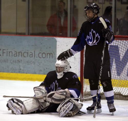 JOE.BRYKSA@FREEPRESS.MB.CA Sports- (See  Ashley's  story)-   Jeanne Sauve Olympians goaltender Braeden Wiley is consoled by teammate Nicolas MArcon-Lajeunesse after he let in a goal to lose the overtime game against the Oak Park Raiders during the semifinal at the  MHSAA Milk Procincials at the MTSIceplex in Headingley, Manitoba Sunday- The win send the Raiders to the final this Wed  against either Westwood Warriors or St Paul's Crusaders- to be determined by game tonight    -   JOE BRYKSA/WINNIPEG FREE PRESS- Mar 13, 2011