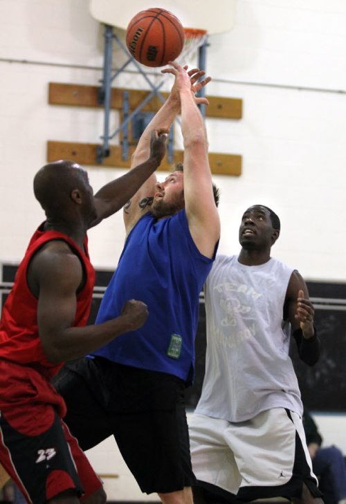 Brandon Sun Eric Olson of Team Dynasty loses hold of the ball under pressure from Extreme Clean's Kevin Phillip (left) and Oneal Gordon, Sunday afternoon during senior mens' basketball semi-final action at Assiniboine Community College. (Colin Corneau/Brandon Sun)