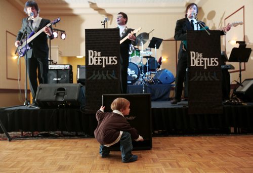 Brandon Sun 17032011 Three-year-old Mason Burgess puts his ear up to a speaker while listening to The Beetles perform at the Dance For Japan benefit social for Japan relief at the Victoria Inn Imperial Ballroom on Thursday evening. 100% of the proceeds from the event will be sent to the relief fund through the Canadian Red Cross. (Tim Smith/Brandon Sun)