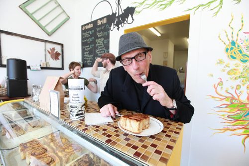 Ruth Bonneville Winnipeg Free Press March 23, 2011 Entertainment -   Citi-FM Howard Mandshein takes a bite of one of Jonnie's Cinnamon buns while owners Jon McPhail and Rheanna Melnick  ham it up in the background at Jonnie's - a Portage Ave. nook that sells cinnamon buns.  See Dave Sanderson's story.