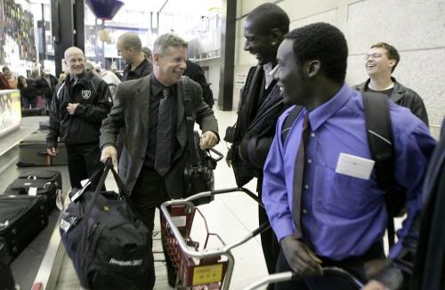 John Woods / Winnipeg Free Press / October 28, 2006 - 061028 - Bison Coach Brian Dobie arrives at the Winnipeg Airport with team players after winning their last game to give them a perfect record for the season Saturday Oct 28/06.   The team is number one in the league.