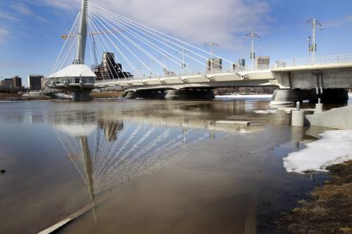 WAYNE.GLOWACKI@FREEPRESS.MB.CA The rising Red River is flooding the walkway by the Esplanade Riel Monday.      Winnipeg Free Press April 4  2011