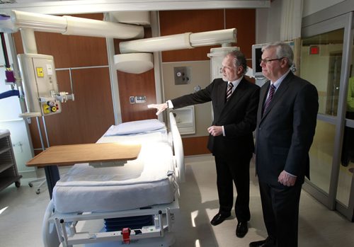 WAYNE.GLOWACKI@FREEPRESS.MB.CA At left, Dr. Alan Menkis, Medical Director, WRHA Cardiac Sciences and Manitoba Premier Greg Selinger tour an intensive care cardiac surgery bed area  at the official opening of the new Cardiac Sciences Bld. in the St. Boniface Hospital's I.H.Asper Institute Monday. The $40.3 million state-of-the-art facility will start receiving patients later this month.  see release.    Winnipeg Free Press April 4  2011