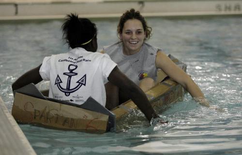 John Woods / Winnipeg Free Press / October 30, 2006 - 061030 - Macey Hickes (R) and Debbie Yeboah of Sisler High School  paddle their cardboard boat at the 1st annual Cardboard Boat Race put on by Skills Manitoba at the 17th Wing swimming pool Oct 30/06.