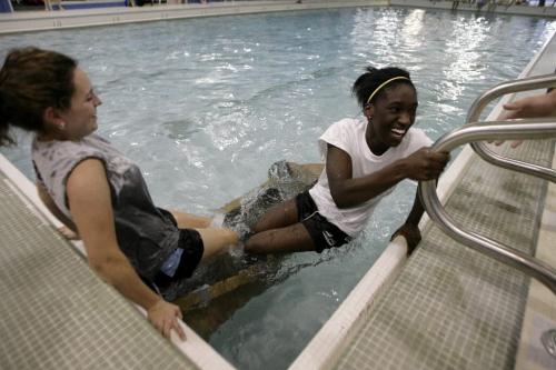 John Woods / Winnipeg Free Press / October 30, 2006 - 061030 - Macey Hickes (L) and Debbie Yeboah of Sisler frantically struggle to get out of their cardboard boat as it sinks at the 1st annual Cardboard Boat Race put on by at the 17th Wing swimming pool Oct 30/06.
