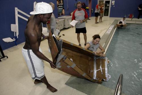 John Woods / Winnipeg Free Press / October 30, 2006 - 061030 - Macey Hickes (R) team mate Richard Asante of Sisler High School pull out their waterlogged boat at the 1st annual Cardboard Boat Race put on by Skills Manitoba at the 17th Wing swimming pool Oct 30/06.
