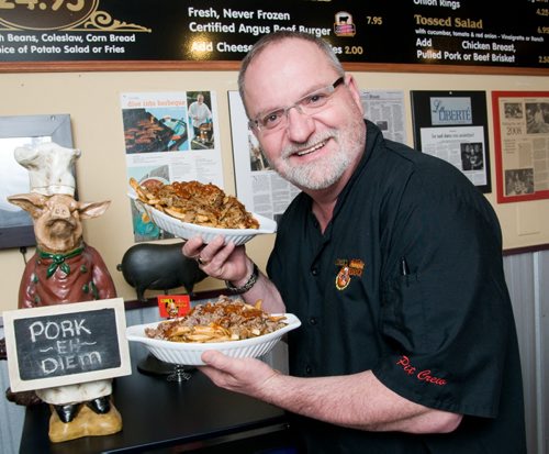 DAVID LIPNOWSKI / WINNIPEG FREE PRESS (April 05, 2011)  Lovey's BBQ owner Roger LeBleu with the their poutine with pulled pork and the poutine with beef.